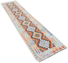 A handmade Afghan Maimana wool runner rug featuring a colorful geometric diamond pattern.