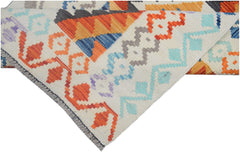 A handmade Afghan Maimana kilim runner featuring vibrant geometric patterns in wool.
