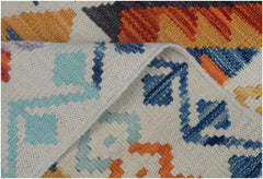 A handmade Afghan Maimana kilim runner featuring a colorful geometric pattern on a cream background.