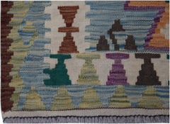 Handwoven Afghan Maimana wool runner featuring colorful geometric motifs on a cream background.