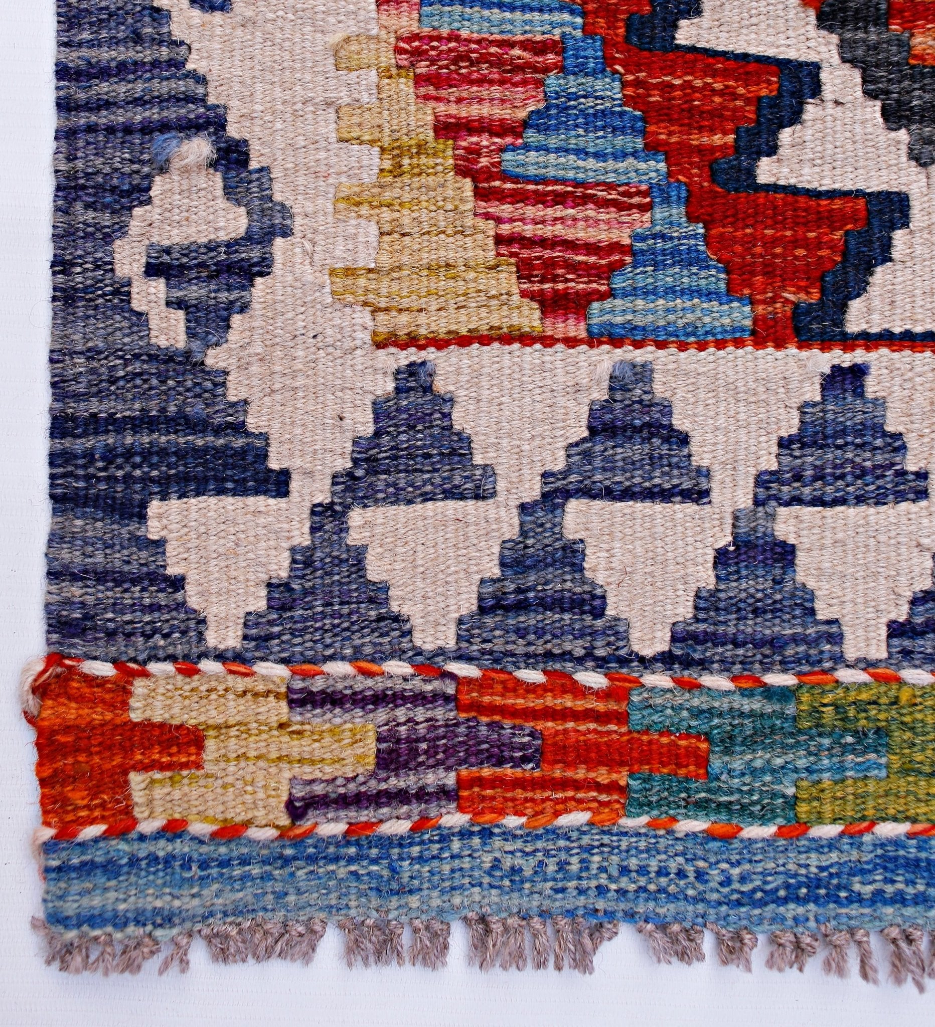 Handwoven Afghan Maimana wool kilim runner featuring geometric patterns in vibrant colors.
