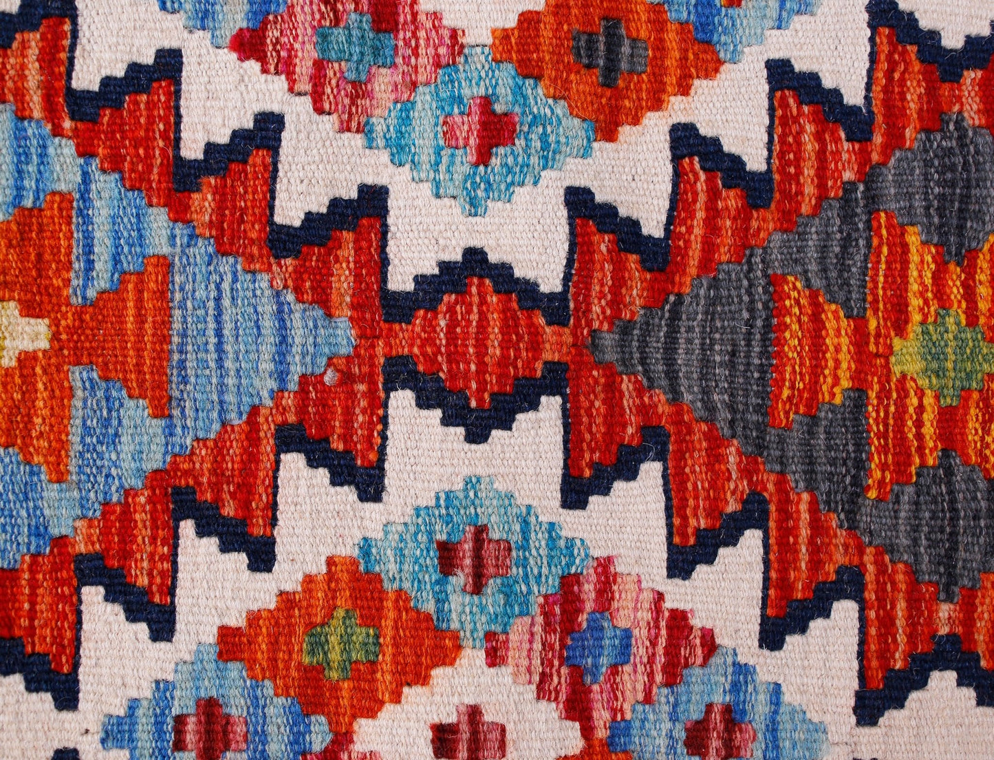 Handwoven Afghan Maimana wool kilim runner featuring a vibrant geometric pattern.
