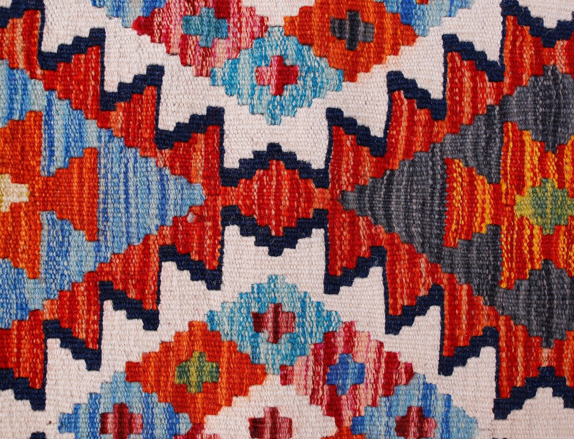 Handwoven Afghan Maimana wool kilim runner featuring a vibrant geometric pattern.