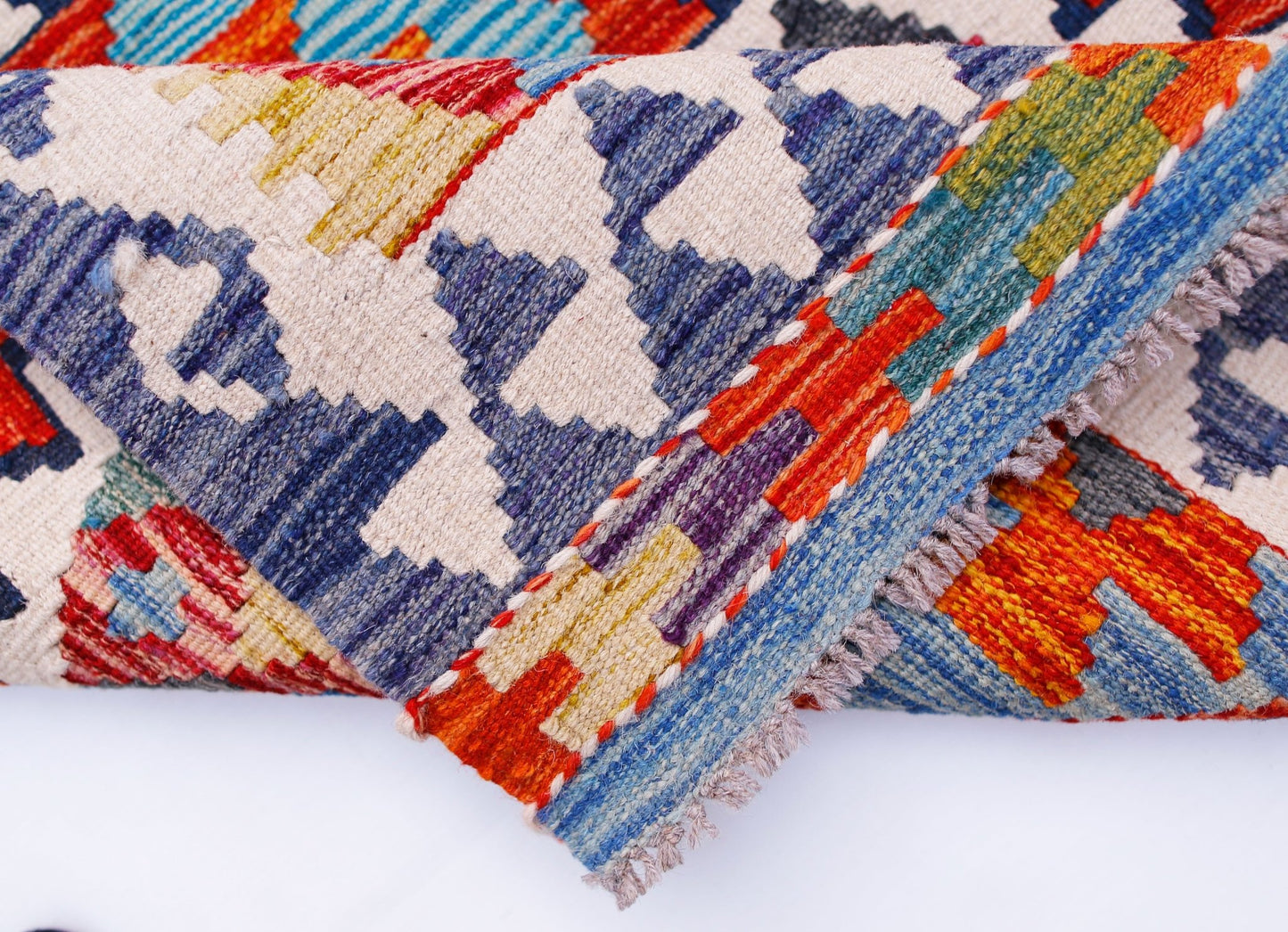 A handwoven Afghan Maimana kilim runner featuring a vibrant geometric pattern in wool.