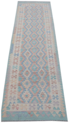 Handmade Afghan Maimana wool runner rug featuring a geometric diamond pattern in pastel colors.
