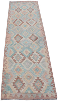 Handmade Afghan Maimana wool runner rug featuring a geometric diamond pattern in pastel tones.