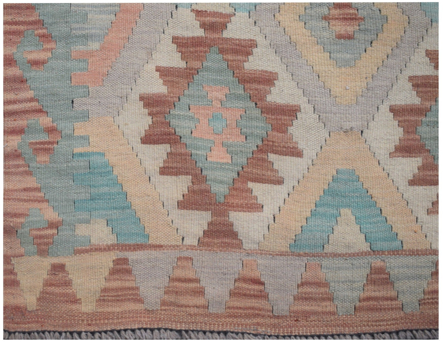 Handmade Afghan Maimana kilim runner featuring a geometric pattern in muted earth tones.