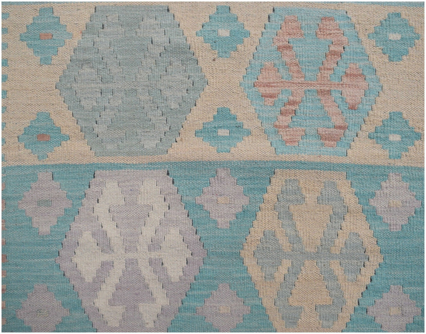 Handmade Afghan Maimana kilim runner featuring a geometric pattern in soft blue and neutral tones.