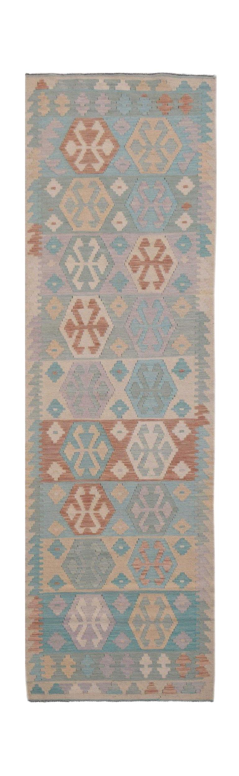 Handmade Afghan Maimana wool runner rug featuring a geometric pattern in muted earth tones.