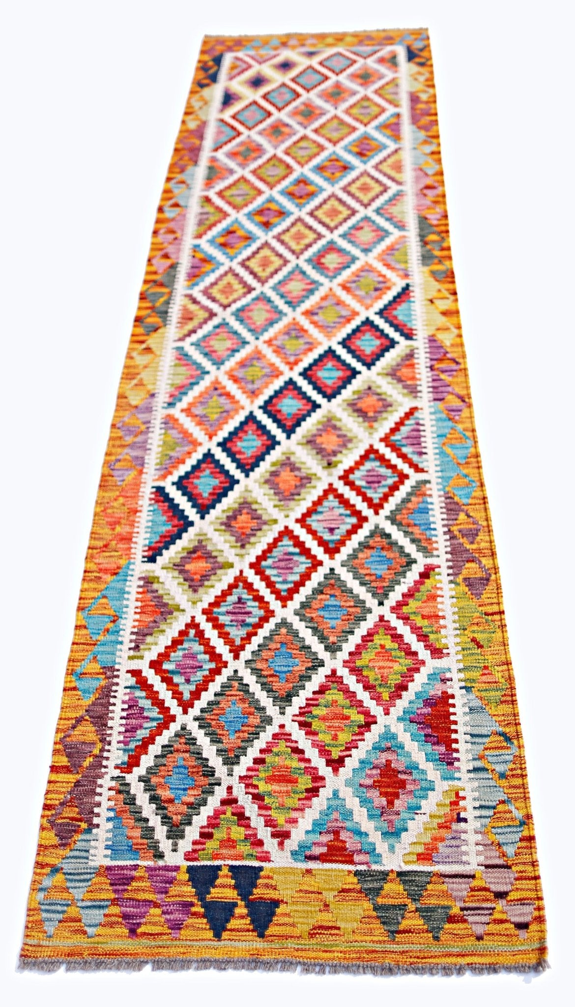 A handmade Afghan Maimana wool runner rug featuring a colorful geometric diamond pattern.