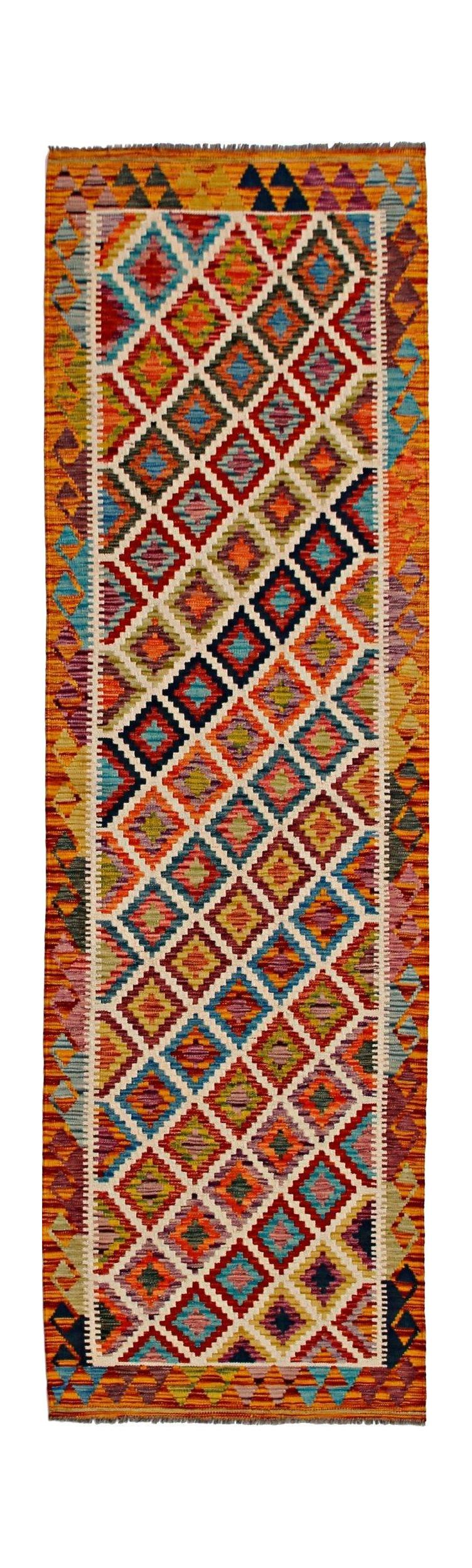 A handmade Afghan Maimana wool runner rug featuring a vibrant, multi-colored geometric diamond pattern.