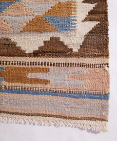 A handwoven Afghan Maimana kilim runner featuring geometric patterns in earthy tones and blue.