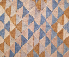 Handwoven Afghan Maimana kilim runner featuring a geometric pattern of blue, tan, and cream triangles.