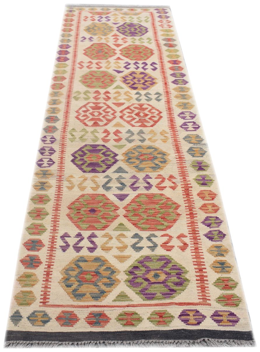 Handmade Afghan Maimana kilim runner featuring colorful geometric patterns on a cream background.