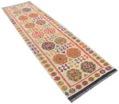 A handmade Afghan Maimana wool runner rug featuring colorful geometric patterns on a cream background.