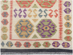 Handmade Afghan Maimana kilim runner featuring colorful geometric patterns on a cream background.