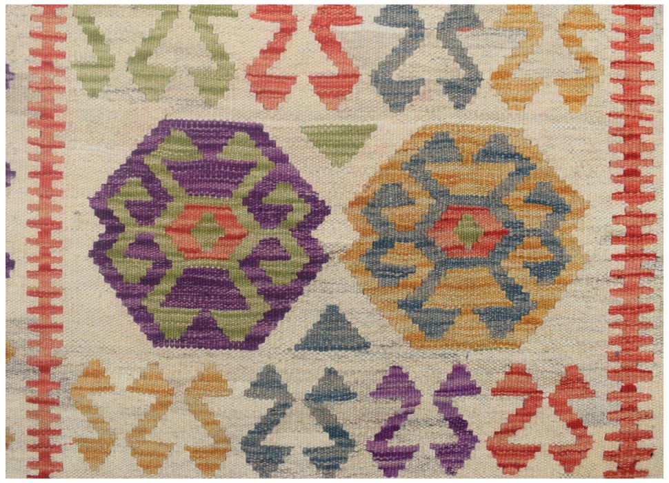 Handmade Afghan Maimana kilim runner featuring colorful geometric patterns on a cream background.