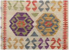 Handmade Afghan Maimana kilim runner featuring colorful geometric patterns on a cream background.