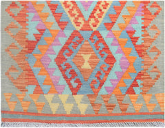 Handmade Afghan Maimana kilim runner featuring a vibrant geometric pattern in wool.
