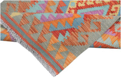 A handmade Afghan Maimana kilim runner featuring vibrant geometric patterns in wool.