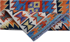A handwoven Afghan Maimana wool kilim runner featuring vibrant geometric patterns and fringe.