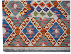 Handwoven Afghan Maimana wool runner featuring a colorful geometric diamond pattern and fringe.