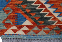 A handwoven Afghan Maimana wool kilim runner featuring a geometric pattern in orange and blue.