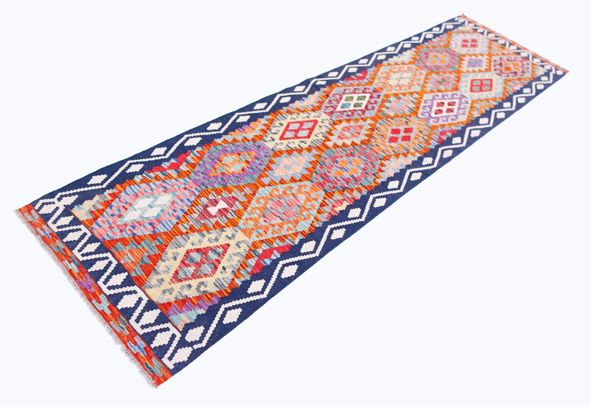 A handmade Afghan Maimana wool runner rug featuring a colorful geometric diamond pattern.