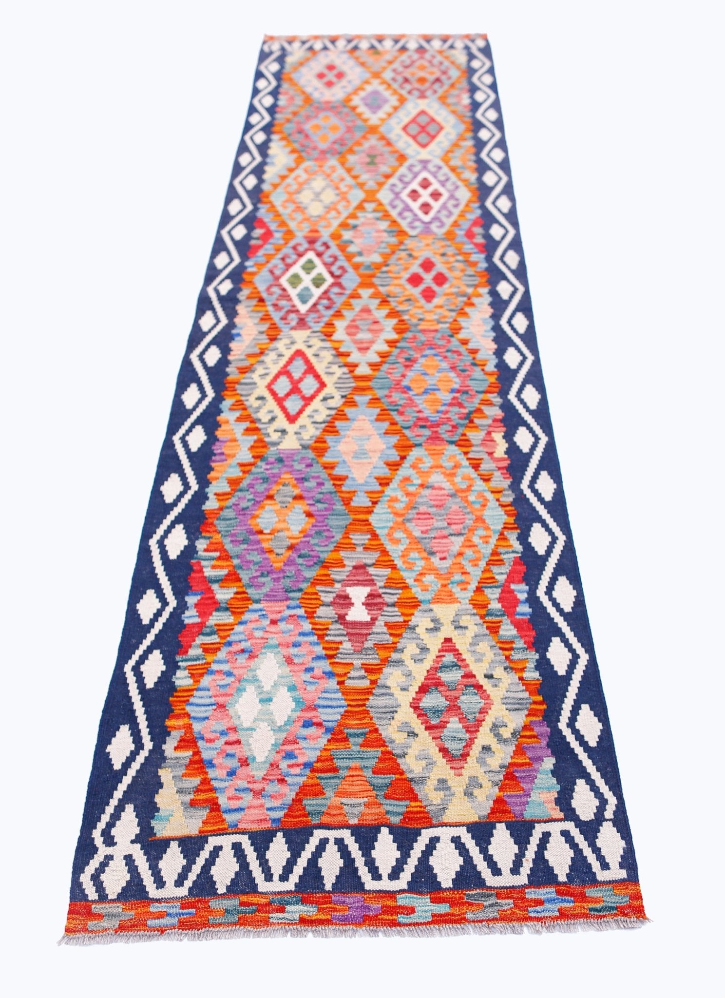 Handwoven Afghan Maimana wool runner rug featuring a colorful geometric diamond pattern.