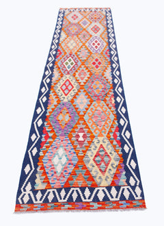 Handwoven Afghan Maimana wool runner rug featuring a colorful geometric diamond pattern.