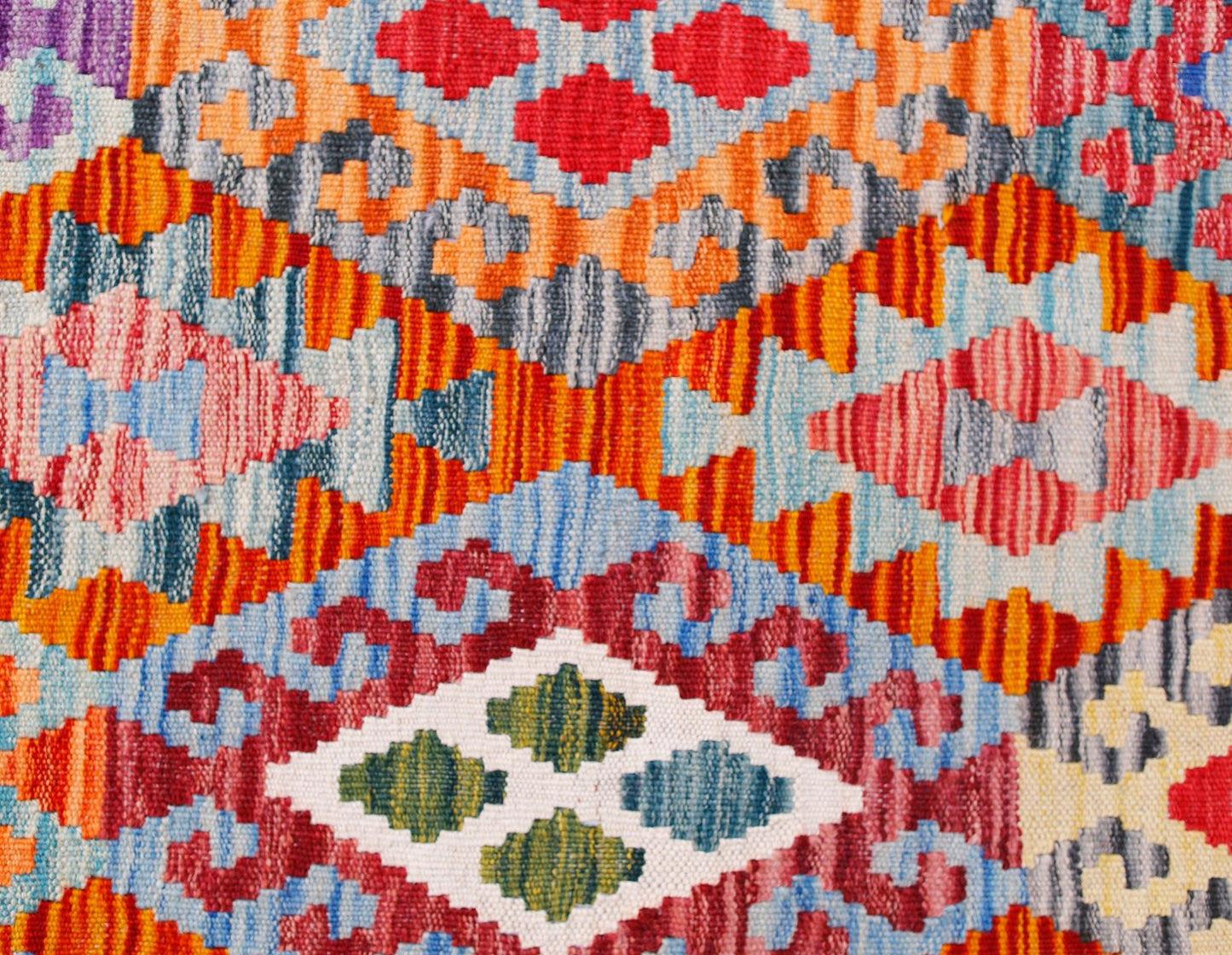 Handwoven Afghan Maimana kilim runner featuring a vibrant geometric pattern in wool.