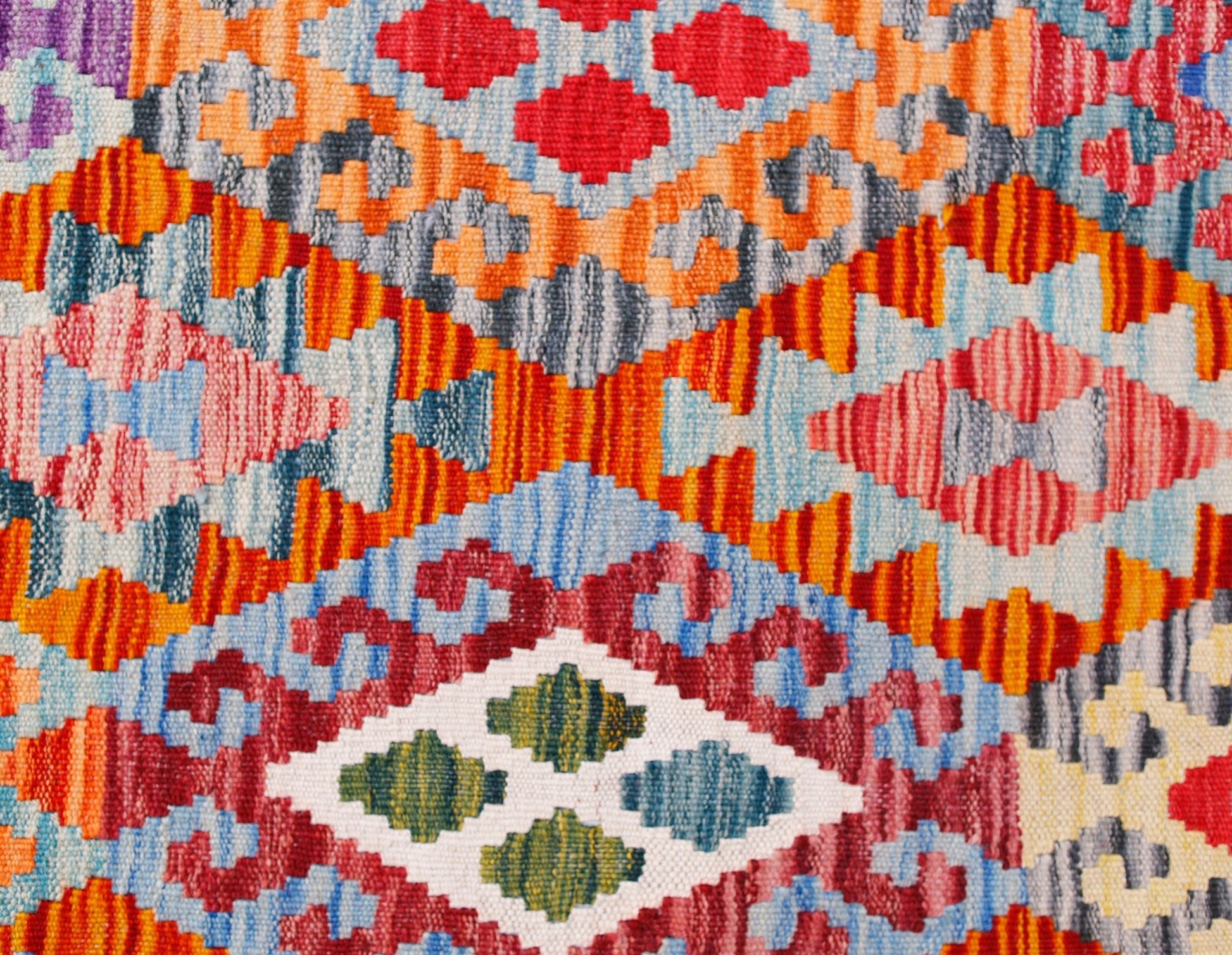 Handwoven Afghan Maimana kilim runner featuring a vibrant geometric pattern in wool.