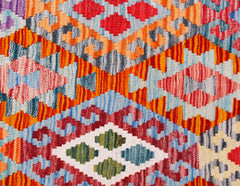 Handwoven Afghan Maimana kilim runner featuring a vibrant geometric pattern in wool.