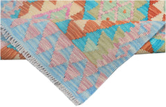 A handmade Afghan Maimana kilim runner featuring a vibrant geometric pattern in wool.