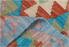 A handmade Afghan Maimana wool kilim runner featuring a geometric pattern in vibrant colors.