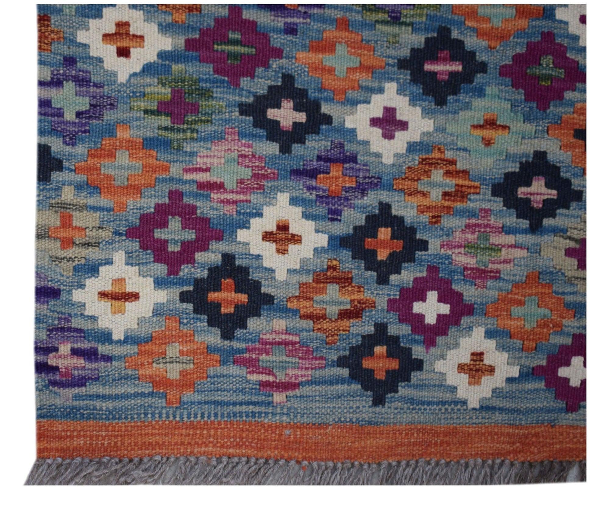 Handwoven Afghan Maimana wool runner featuring a colorful geometric diamond pattern on a blue base.