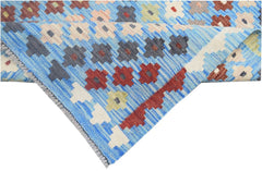 A handmade Afghan Maimana kilim runner featuring a blue background with geometric floral patterns.