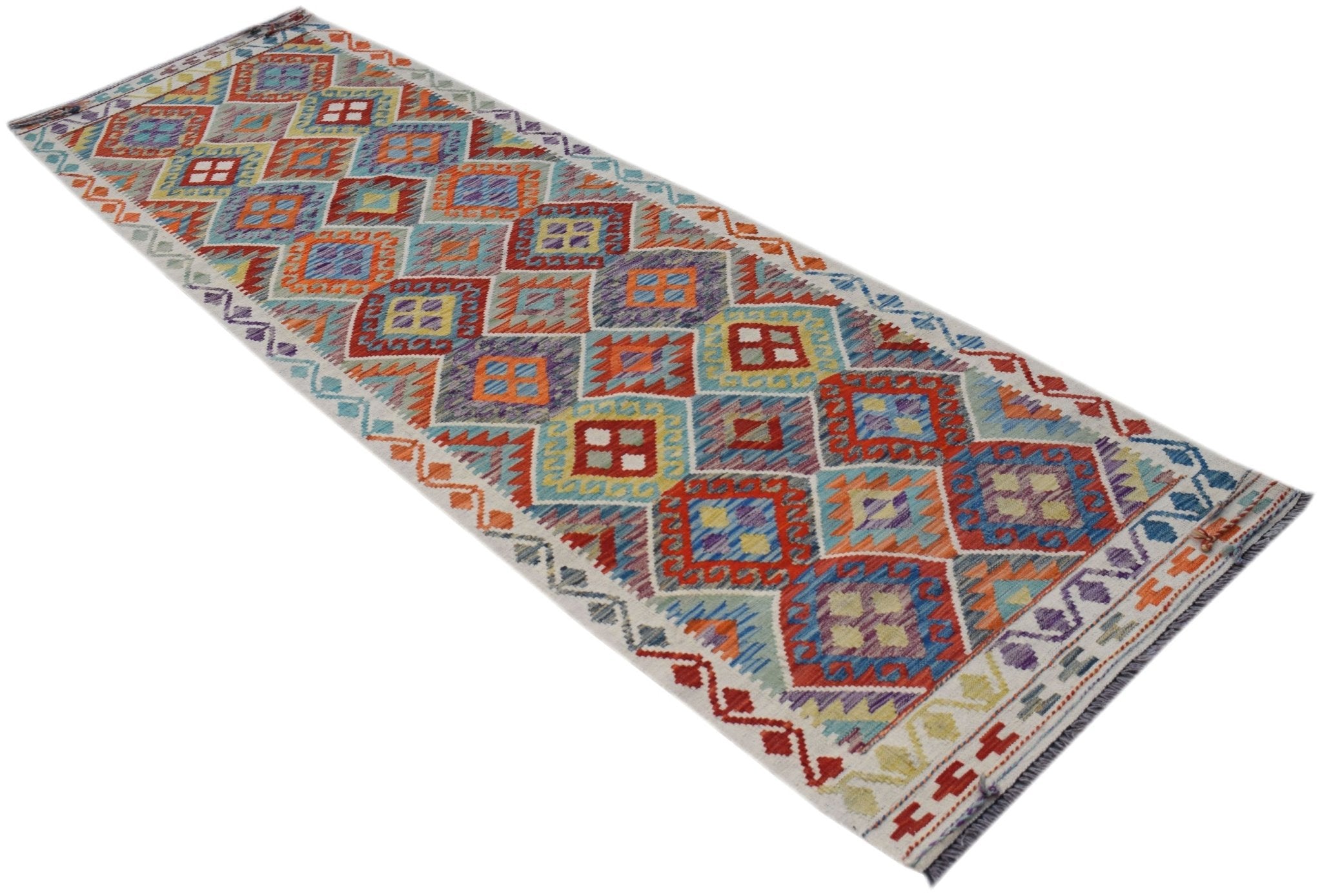 A handmade Afghan Maimana wool runner rug featuring a colorful geometric diamond pattern.