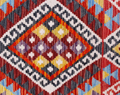 A handmade Afghan Maimana kilim runner featuring a vibrant geometric diamond pattern in wool.