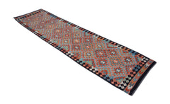 A handmade Afghan Maimana wool runner rug featuring a geometric diamond pattern in vibrant colors.