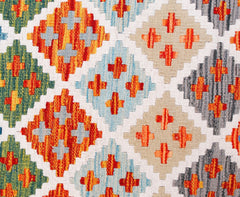 A handmade Afghan Maimana kilim runner featuring a colorful geometric diamond pattern in wool.