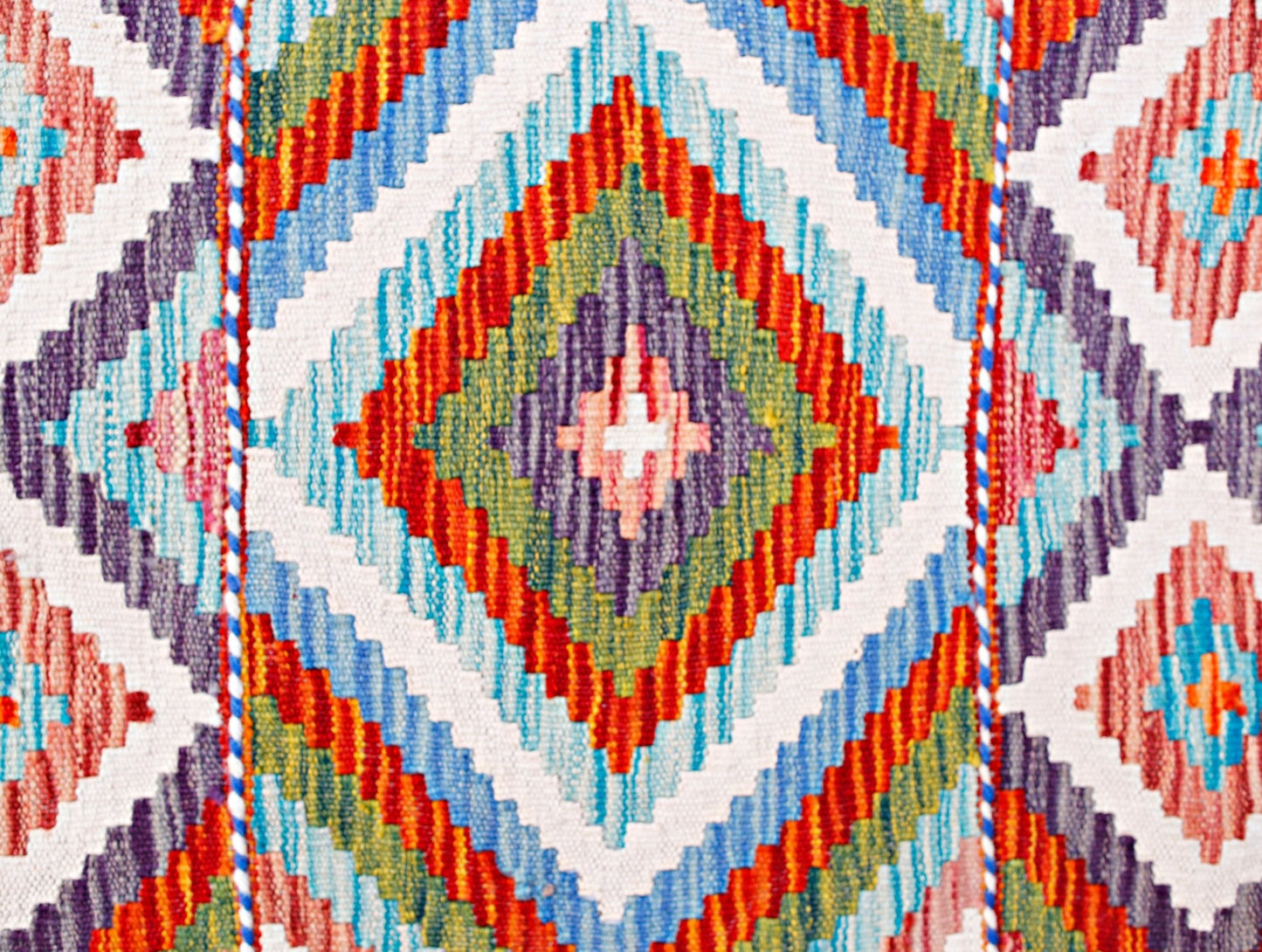 Handwoven Afghan Maimana wool runner featuring a vibrant geometric diamond pattern.