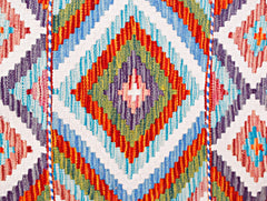 Handwoven Afghan Maimana wool runner featuring a vibrant geometric diamond pattern.