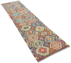 A handmade Afghan Maimana wool runner rug featuring a colorful geometric pattern.