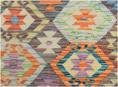 A handmade Afghan Maimana kilim runner featuring a vibrant, geometric diamond pattern in wool.