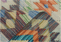 A handmade Afghan Maimana kilim runner featuring a vibrant geometric pattern in wool.