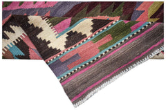 A handmade Afghan Maimana wool kilim runner featuring a colorful geometric pattern.