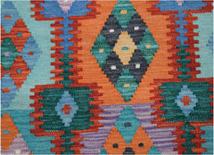 Handwoven Afghan Maimana kilim runner featuring a vibrant geometric pattern in wool.