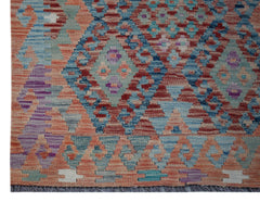 Handwoven Afghan Maimana wool runner featuring a geometric diamond pattern in vibrant colors.