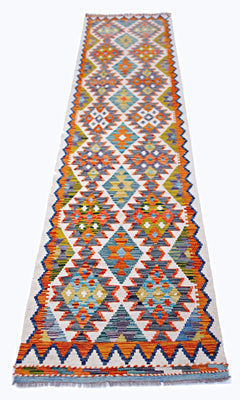 Handwoven Afghan Maimana wool runner featuring a vibrant geometric diamond pattern.